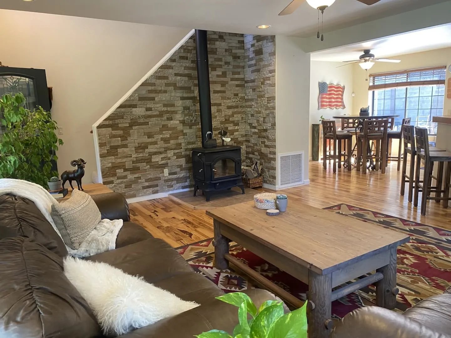 The great room, with its stone fireplace and handcrafted log furniture